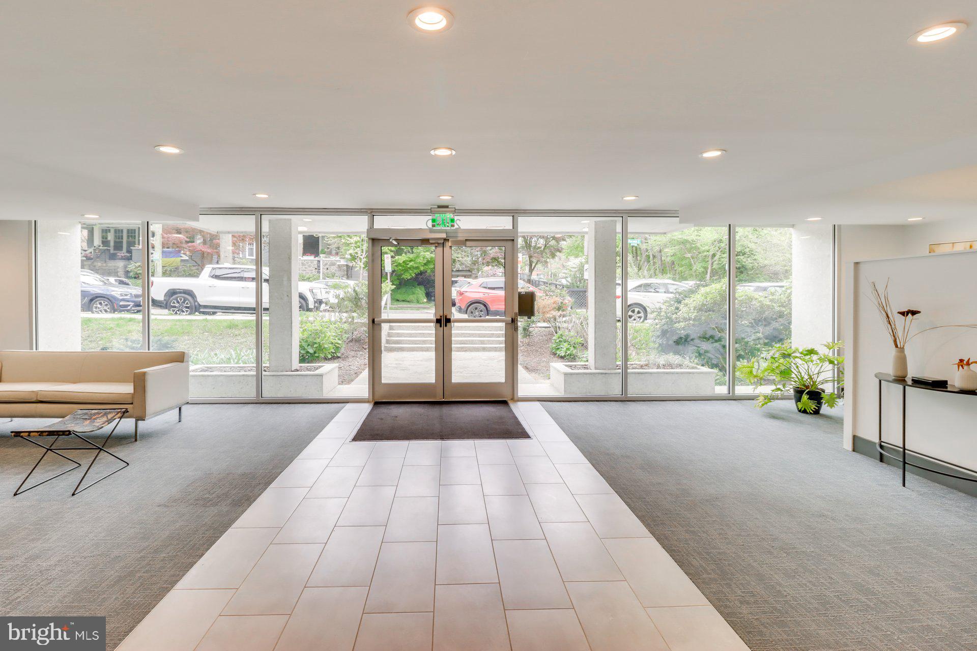 a spacious bedroom with a large window and a balcony