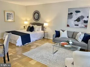 a bedroom with bed and a couch