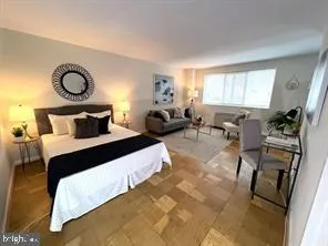 a bedroom with bed chair and window