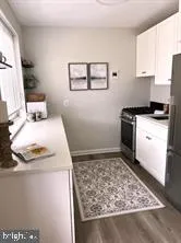 a kitchen with a stove a sink and a refrigerator
