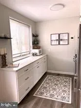 a kitchen with a stove and white cabinets