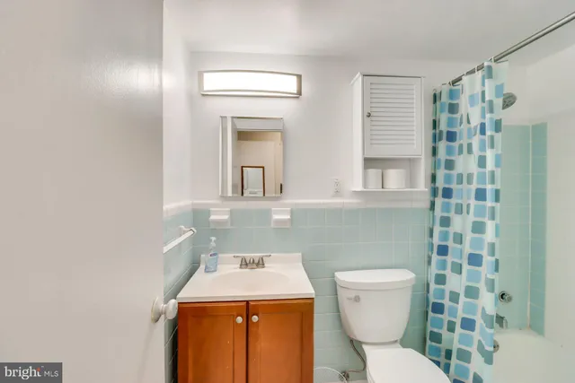 a bathroom with a toilet a sink and a mirror