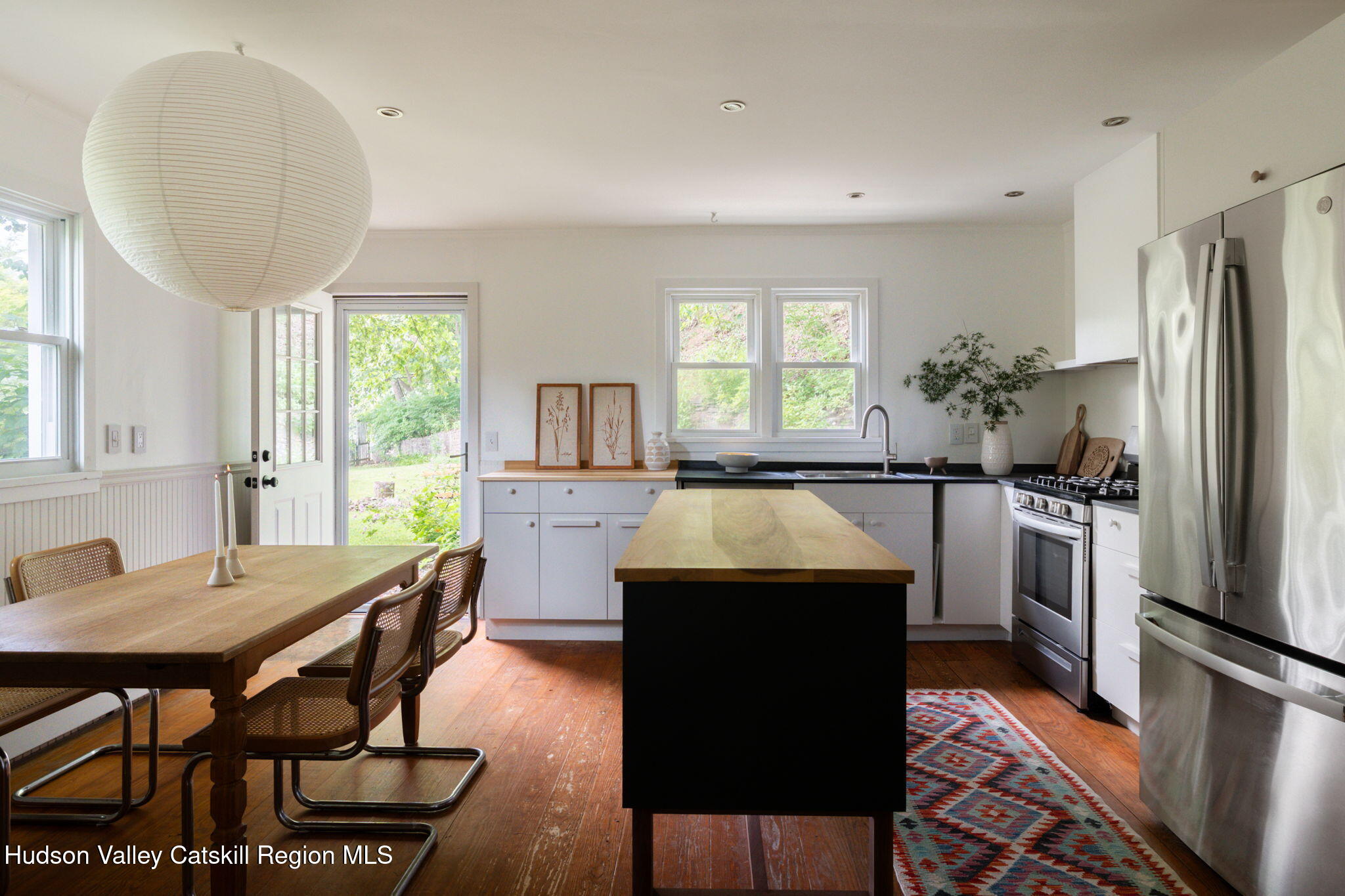 442 Lapla Road Kingston, NY 12401 - Photo 6 of 26 a kitchen with a table chairs refrigerator and window