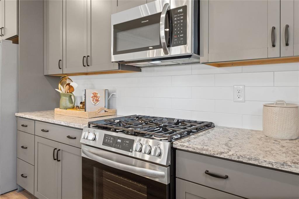 80 Cove Road Ringgold, GA 30736 - Photo 11 of 37 a kitchen with granite countertop white cabinets and appliances