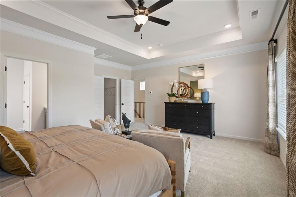 80 Cove Road Ringgold, GA 30736 - Photo 26 of 37 a bedroom with a bed and a chandelier