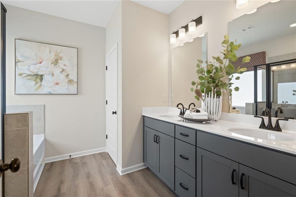80 Cove Road Ringgold, GA 30736 - Photo 28 of 37 a bathroom with a granite countertop sink a mirror and vanity
