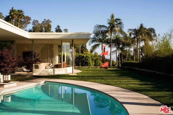 a swimming pool view with a outdoor seating