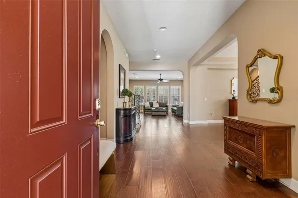 a view of a living room and kitchen with furniture wooden floor and windows