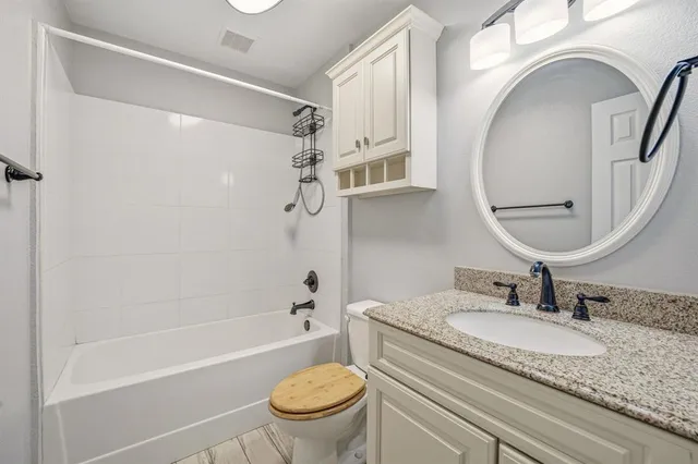 a view of a room with a ceiling fan and window