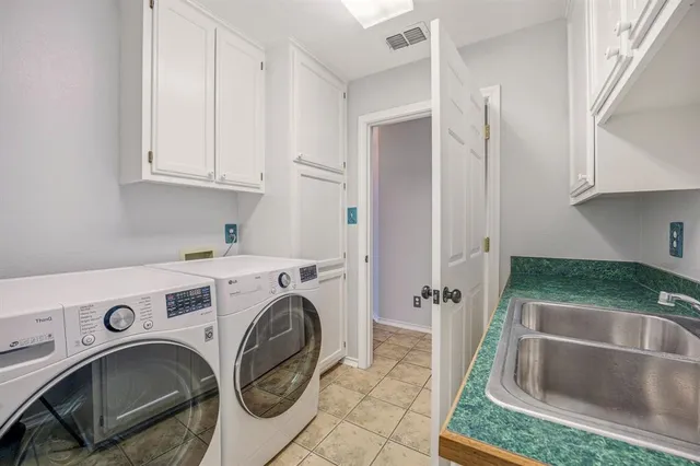 a view of an empty room with wooden floor and windows