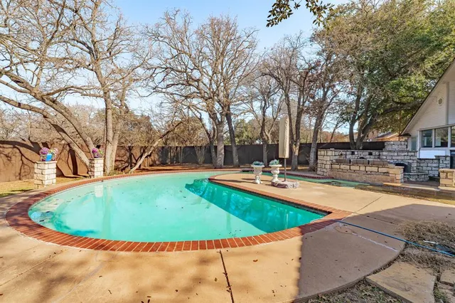 a view of a house with swimming pool and sitting area