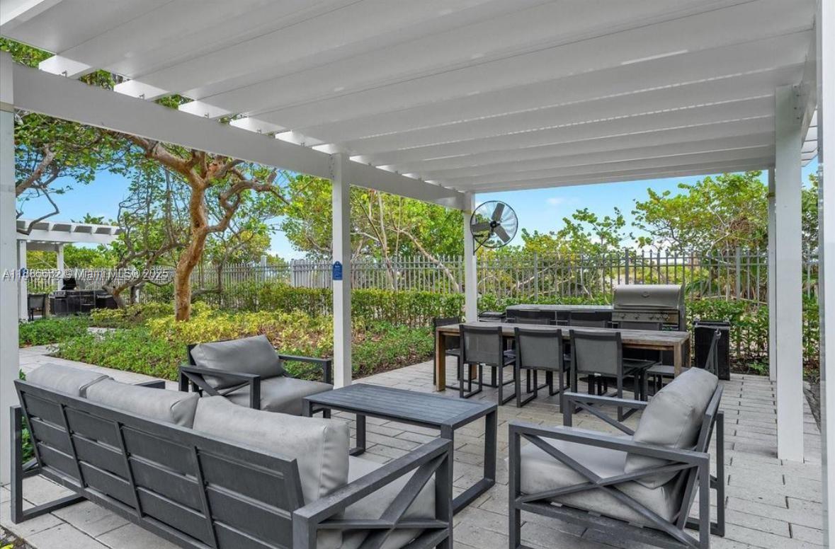 199 Ocean Ln Drive, Unit 115 Key Biscayne, FL 33149 - Photo 14 of 24 a view of a patio with a backyard dining table and chairs