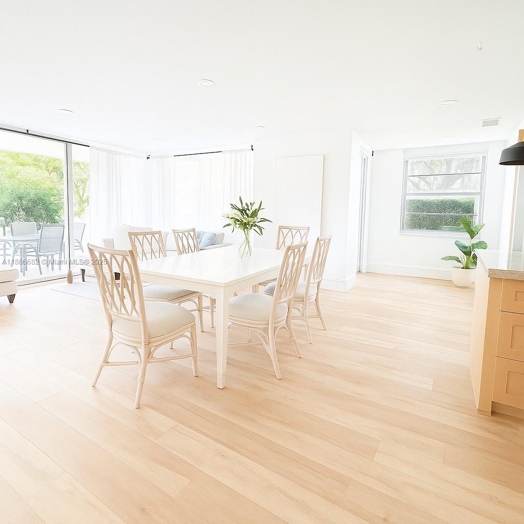 199 Ocean Ln Drive, Unit 115 Key Biscayne, FL 33149 - Photo 4 of 24 a dining room with furniture and wooden floor
