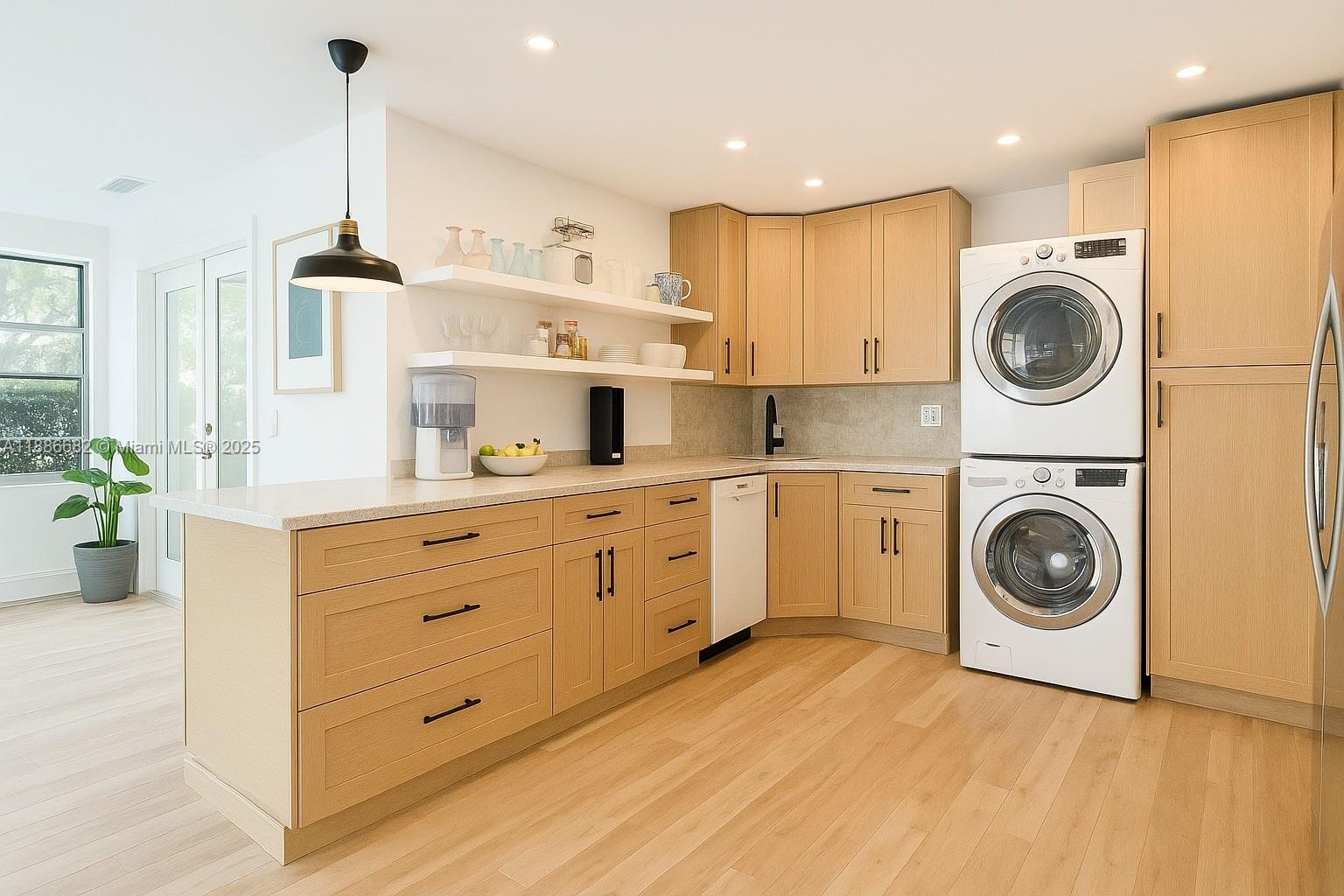 199 Ocean Ln Drive, Unit 115 Key Biscayne, FL 33149 - Photo 6 of 24 a kitchen with cabinets a washer and dryer