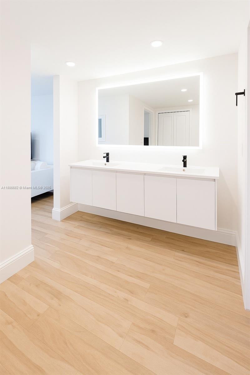 199 Ocean Ln Drive, Unit 115 Key Biscayne, FL 33149 - Photo 10 of 24 a bathroom with a sink mirror and a bath tub