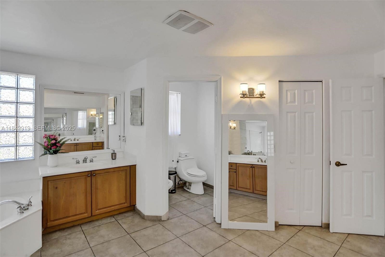 721 Ranch Road Weston, FL 33326 - Photo 25 of 38 a room with a washing machine and mirrors