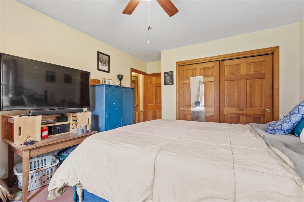 340 Ball Hill Road Princeton, MA 01541 - Photo 30 of 41 a bedroom with a bed and a flat screen tv