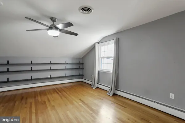 a view of a room with window and ceiling fan