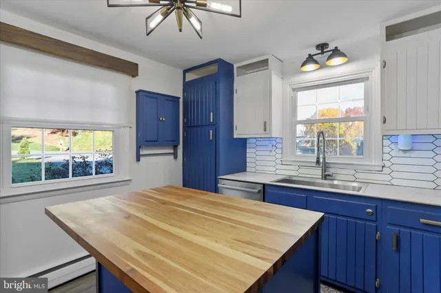 a kitchen with a stove a sink and a window