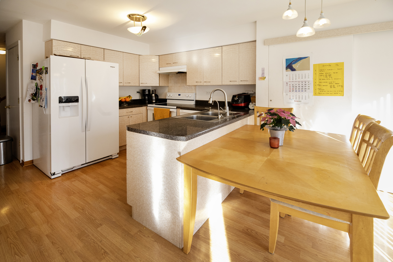 317 Partridge Lane Wheeling, IL 60090 - Photo 7 of 22 a kitchen with stainless steel appliances a refrigerator a sink a stove a dining table and chairs