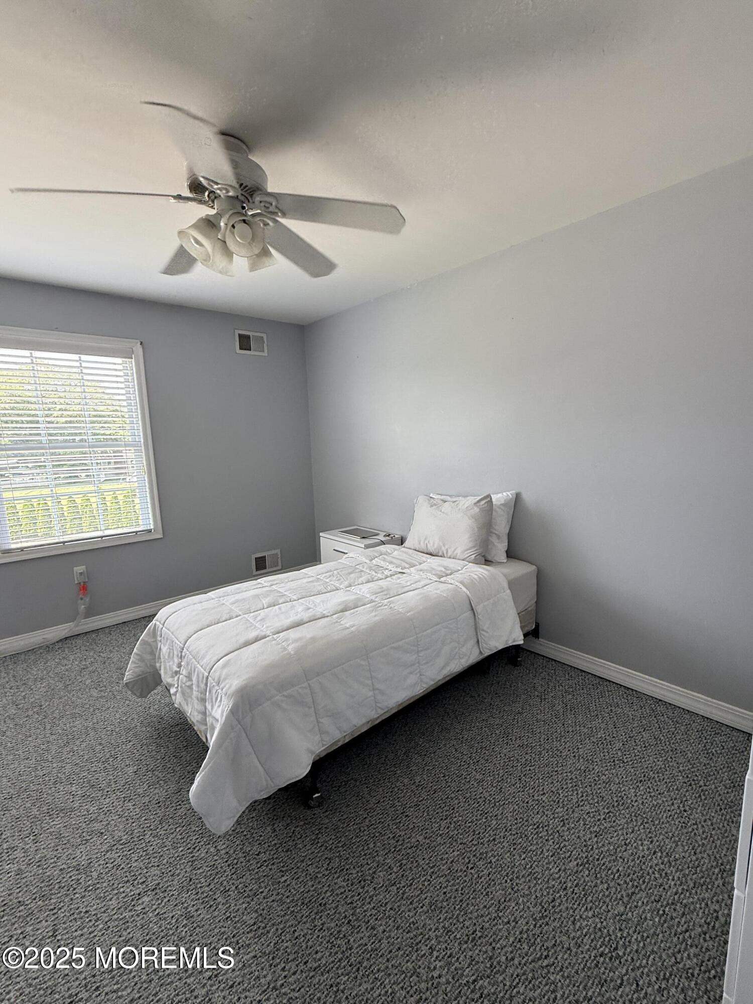 519 2nd Avenue Long Branch, NJ 07740 - Photo 18 of 24 a bedroom with a bed and window