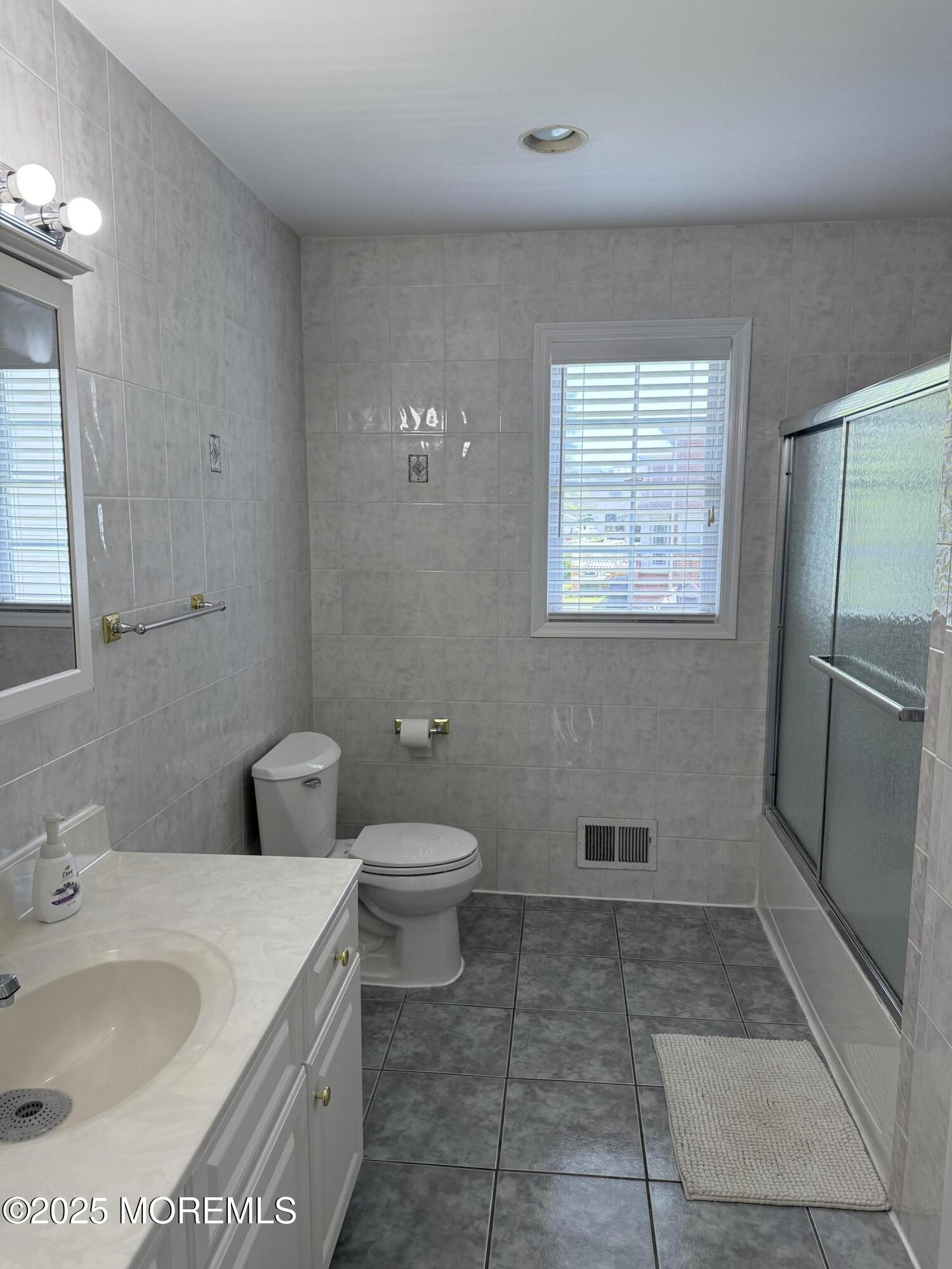 519 2nd Avenue Long Branch, NJ 07740 - Photo 20 of 24 a bathroom with a sink a toilet and shower