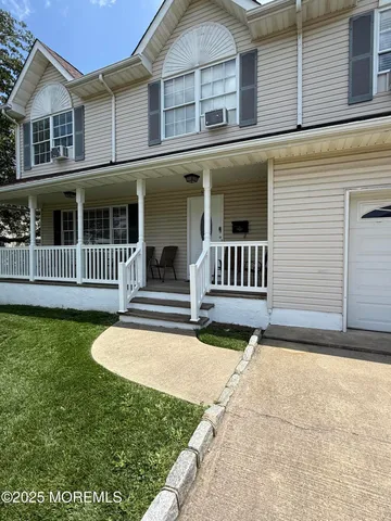 a view of a house with a yard and deck