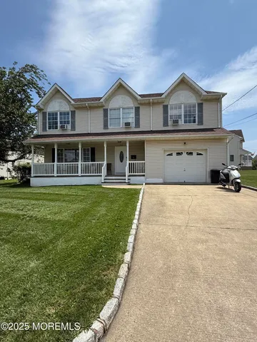 a front view of a house with a yard table and chairs