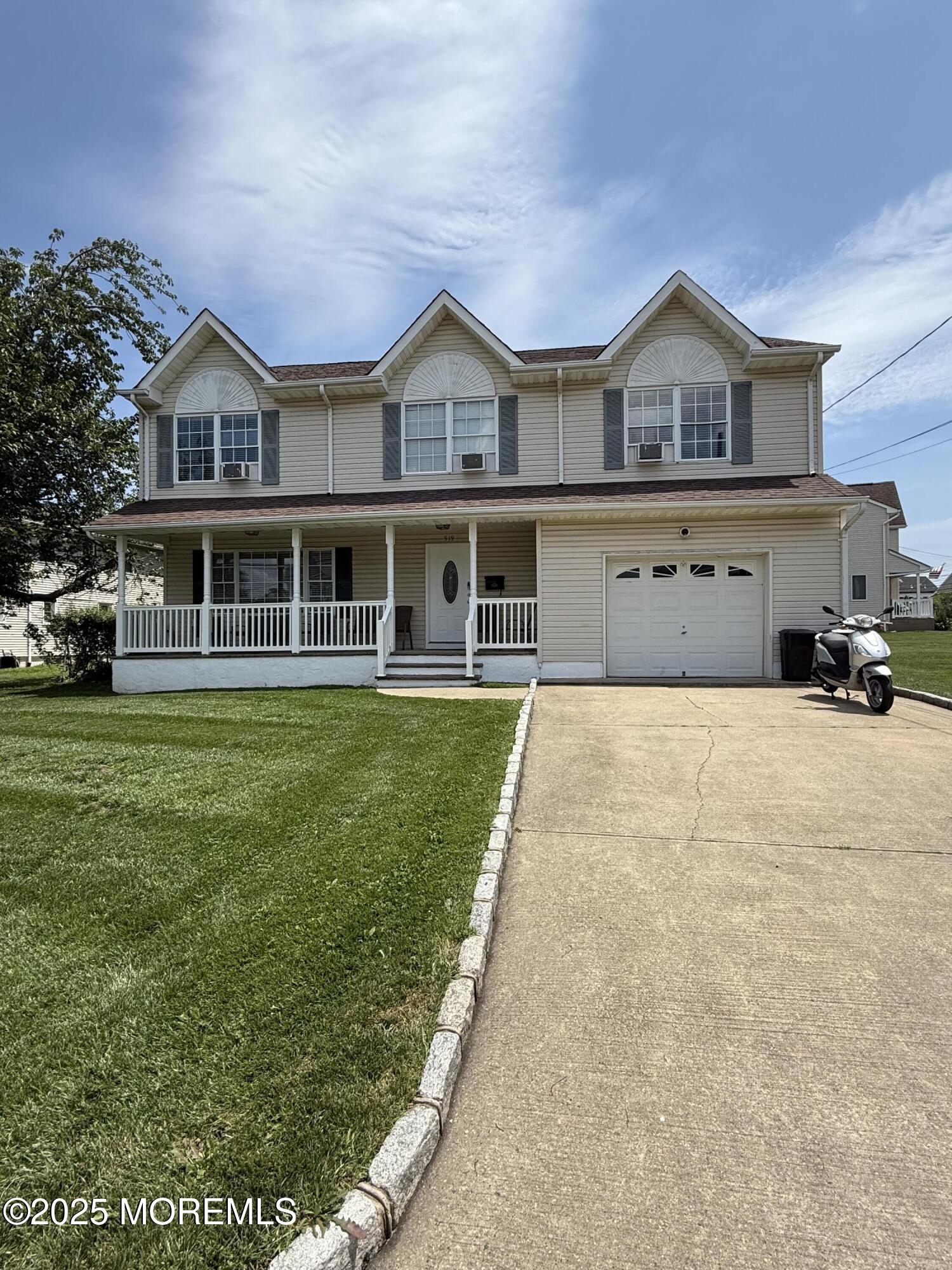 519 2nd Avenue Long Branch, NJ 07740 - Photo 3 of 24 a front view of a house with a yard table and chairs