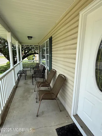 a view of two chairs in the balcony