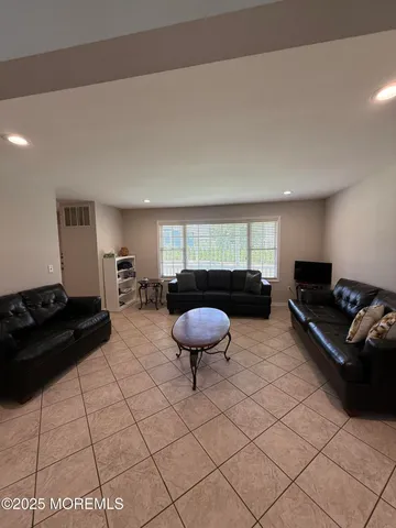 a living room with furniture and a rug