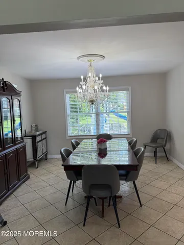 a view of a dining room with furniture and chandelier