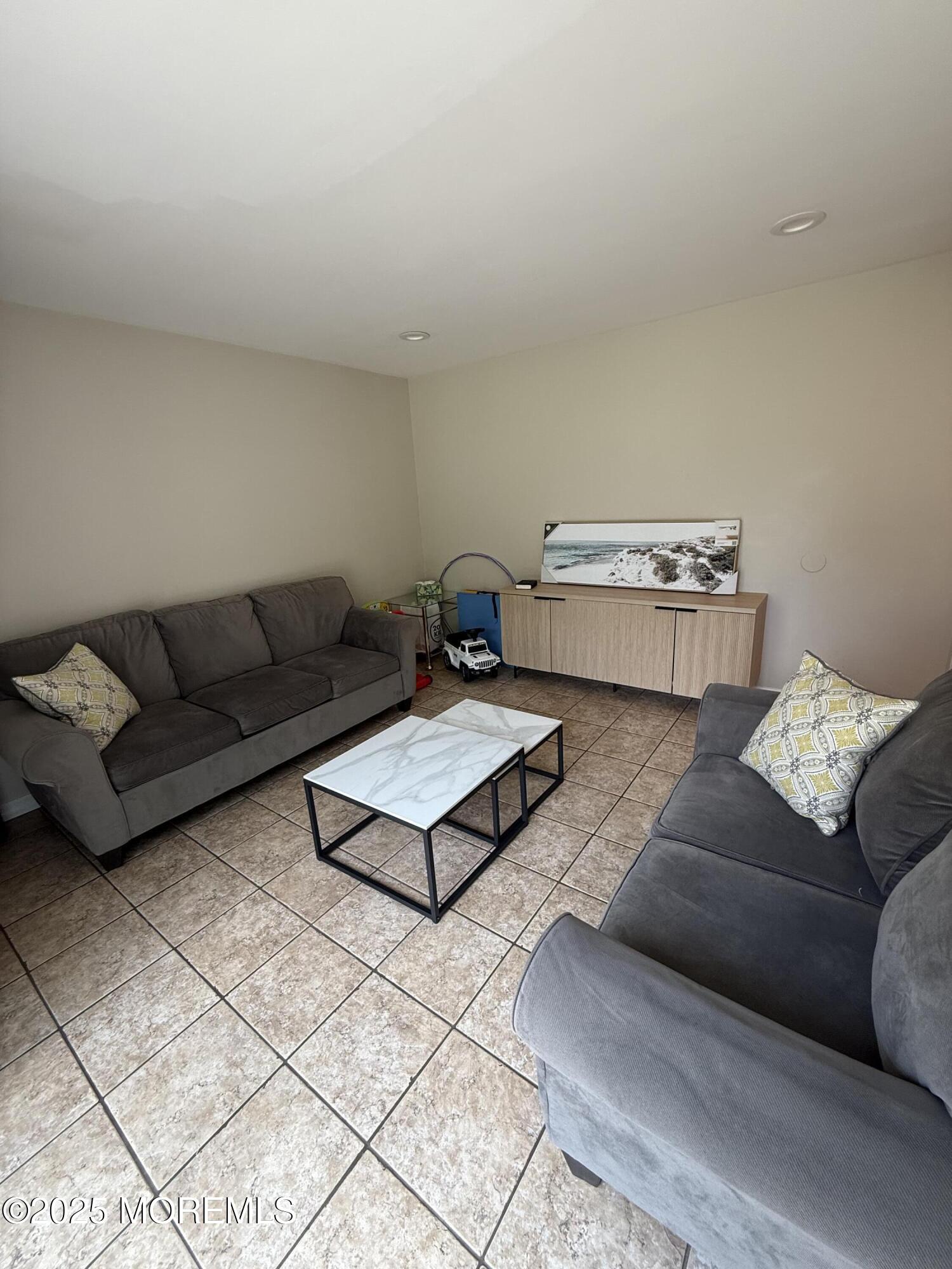 519 2nd Avenue Long Branch, NJ 07740 - Photo 9 of 24 a living room with furniture and a couch