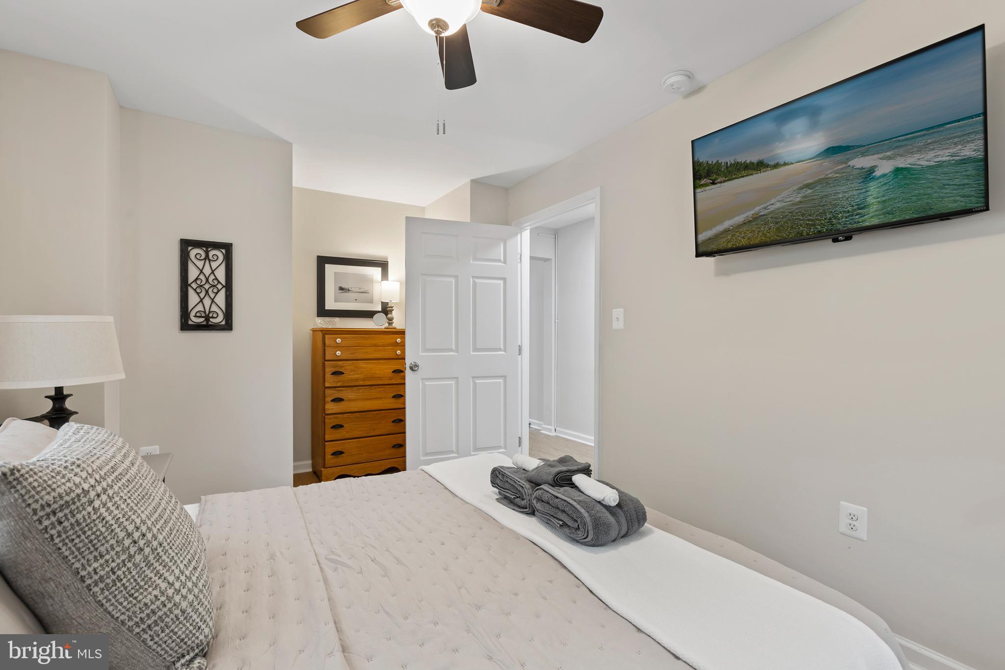 1900 Princess Anne Street, Unit 6 Fredericksburg, VA 22401 - Photo 14 of 19 a bedroom with a bed and a flat screen tv