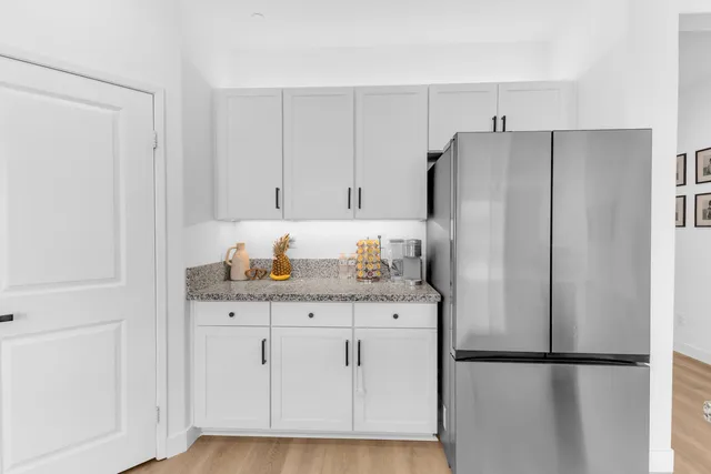 a kitchen with stainless steel appliances granite countertop a refrigerator and a stove