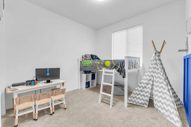 a view of a workspace with furniture and a window