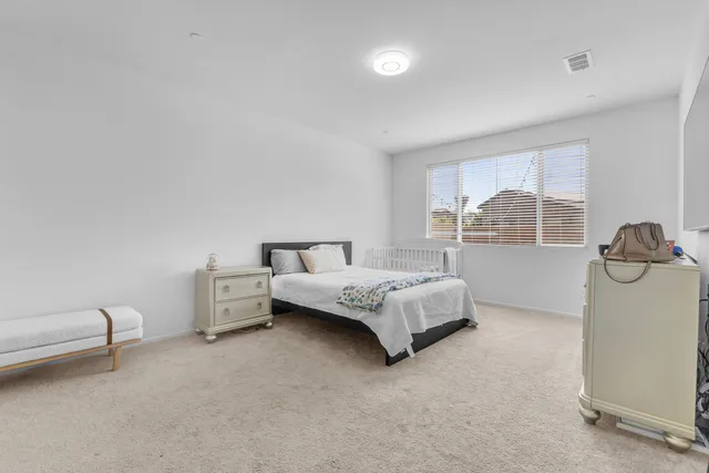 a bedroom with a bed and a lamp with window