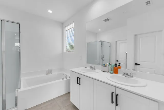 a white bath tub sitting next to a shower