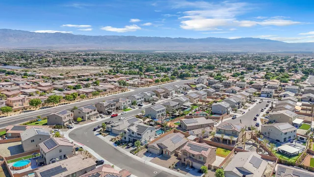 an aerial view of residential houses with city view