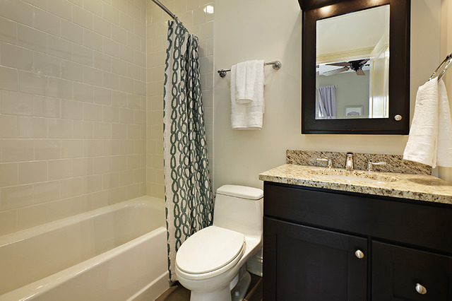 2246 Illinois Road Northbrook, IL 60062 - Photo 16 of 25 a bathroom with a granite countertop sink toilet and shower