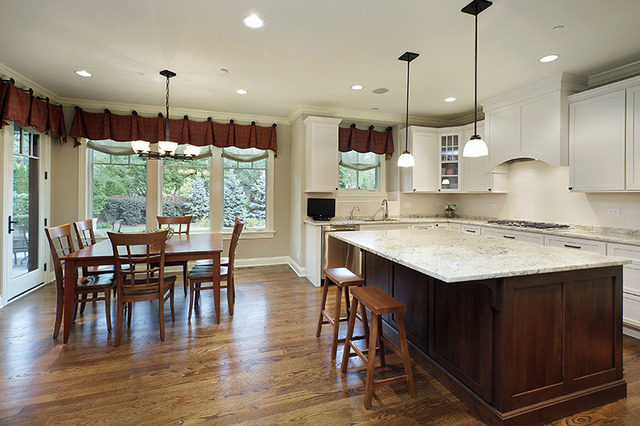 2246 Illinois Road Northbrook, IL 60062 - Photo 3 of 25 a kitchen with stainless steel appliances granite countertop a stove a refrigerator a kitchen island a dining table and chairs with wooden floor