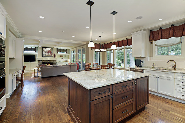 2246 Illinois Road Northbrook, IL 60062 - Photo 4 of 25 a kitchen with kitchen island granite countertop wooden floors and white cabinets