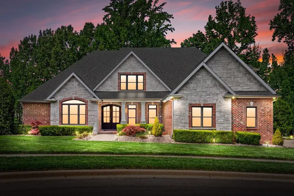 a front view of a house with a yard