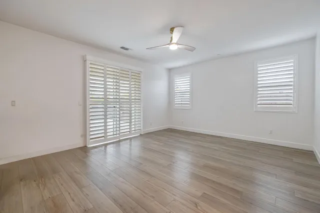 an empty room with a empty space and windows