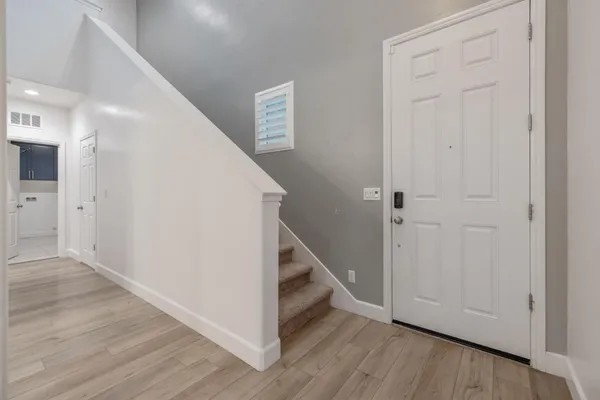 a view of an empty room with wooden floor