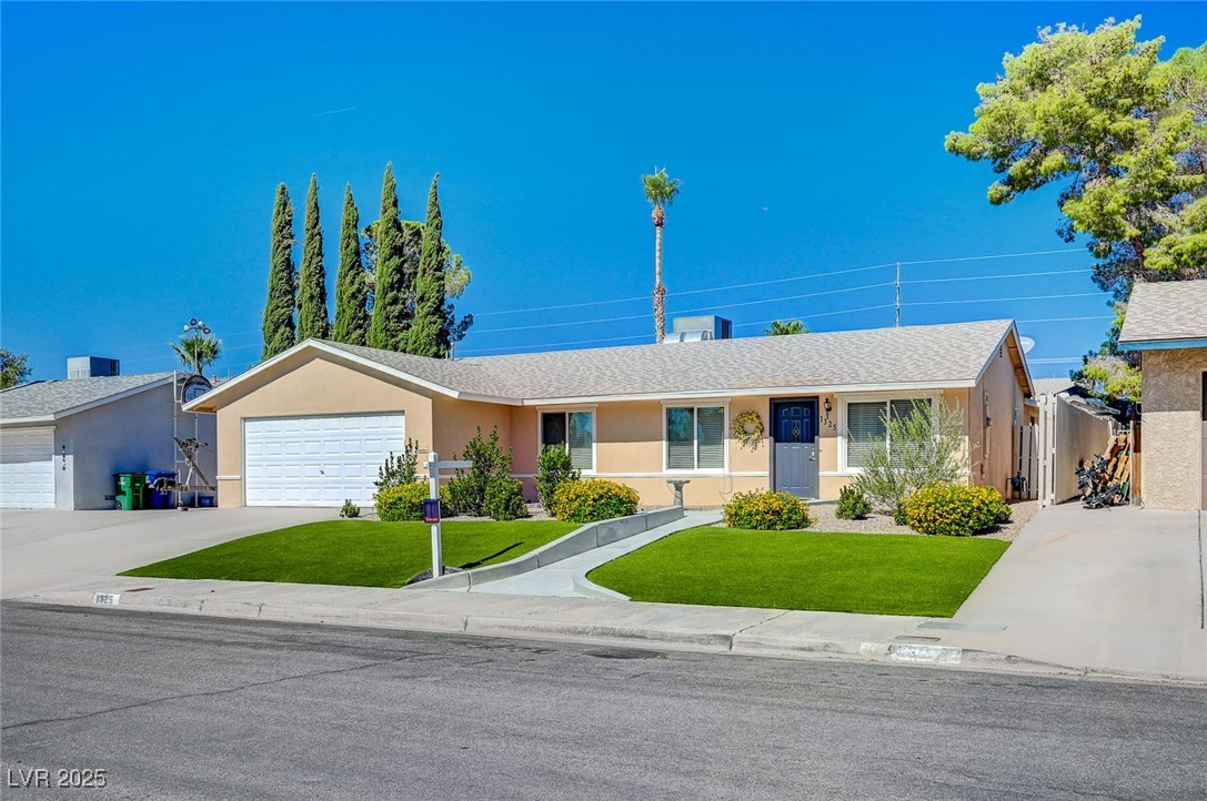 Ranch-style house with stucco siding, a front lawn, driveway, and a garage