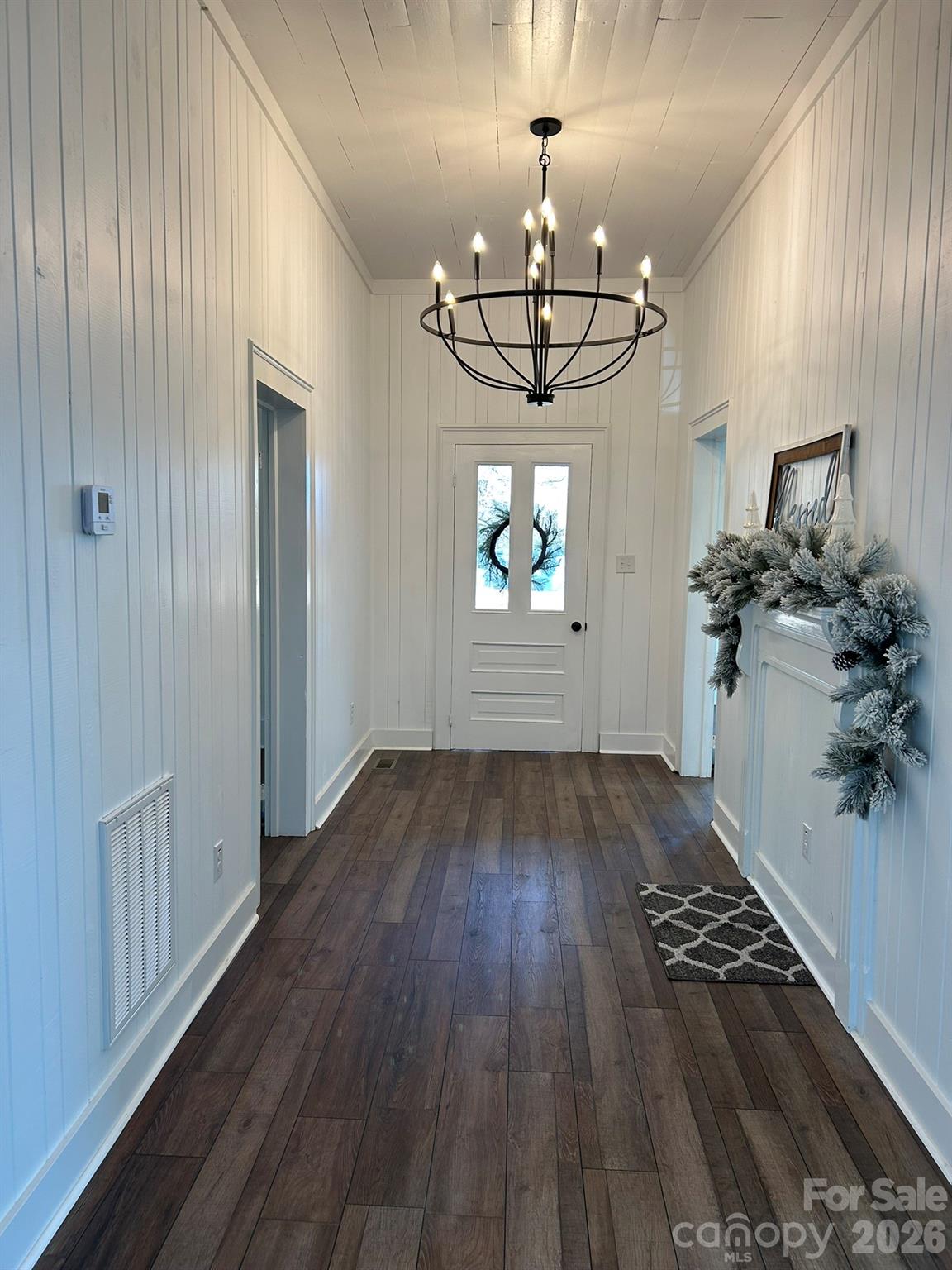 464 Hamrick Road Mooresboro, NC 28114 - Photo 15 of 47 a view of a room with wooden floor chandeliers and kitchen appliances