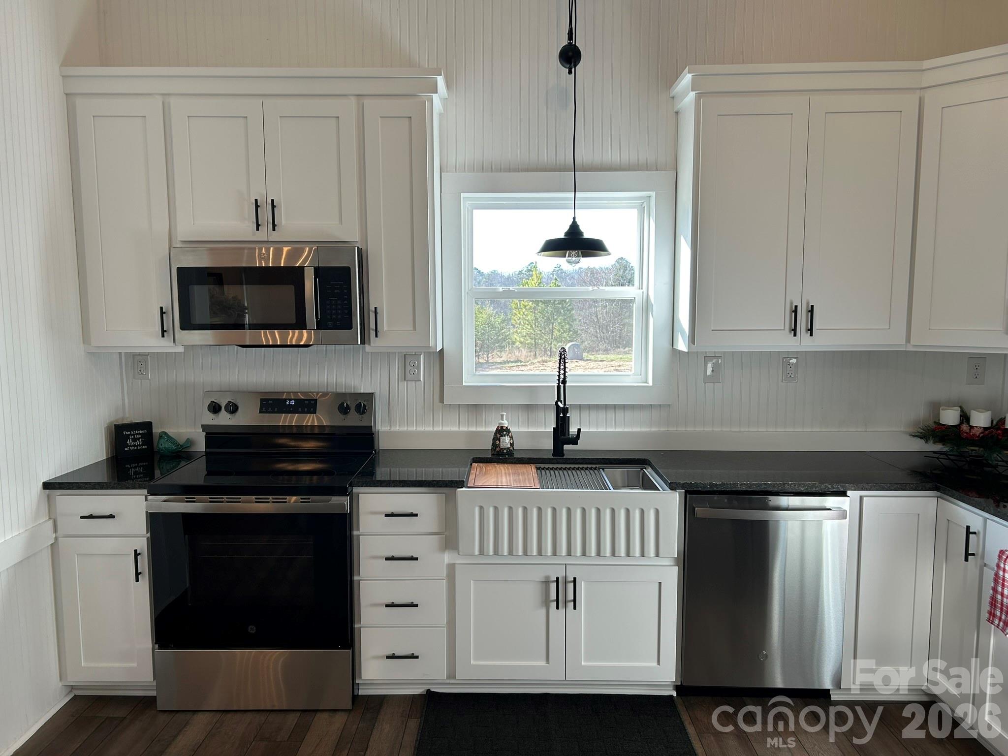 464 Hamrick Road Mooresboro, NC 28114 - Photo 20 of 47 a kitchen with stainless steel appliances granite countertop a stove a sink and a microwave