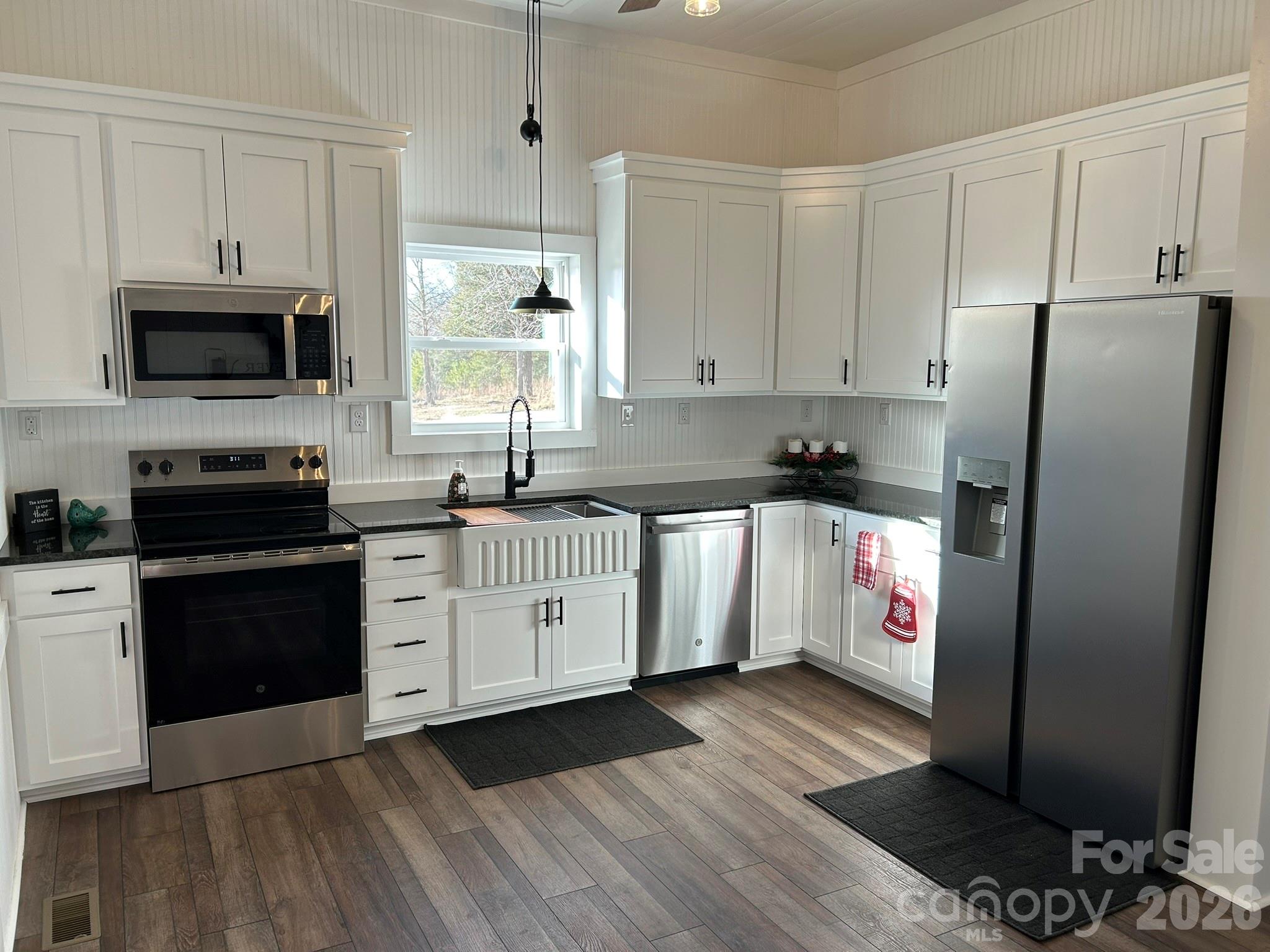 464 Hamrick Road Mooresboro, NC 28114 - Photo 21 of 47 a kitchen with granite countertop a refrigerator stove top oven and sink