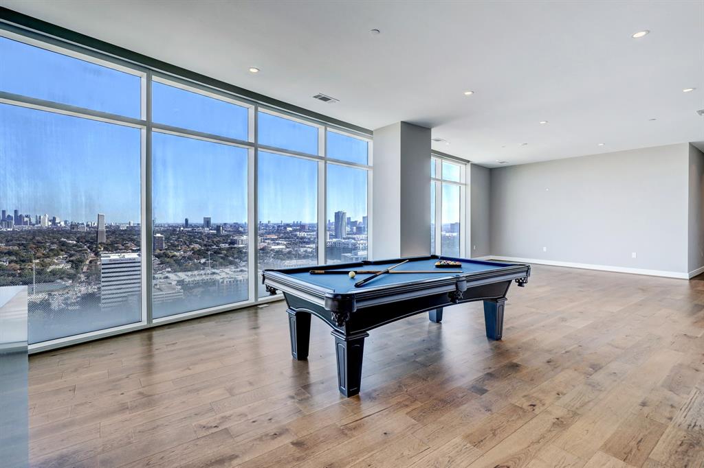 a room with pool table and glass walls